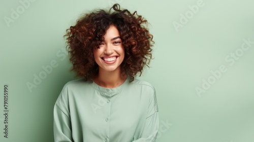 Radiant Young Woman with Curly Hair Smiling Against Pastel Background