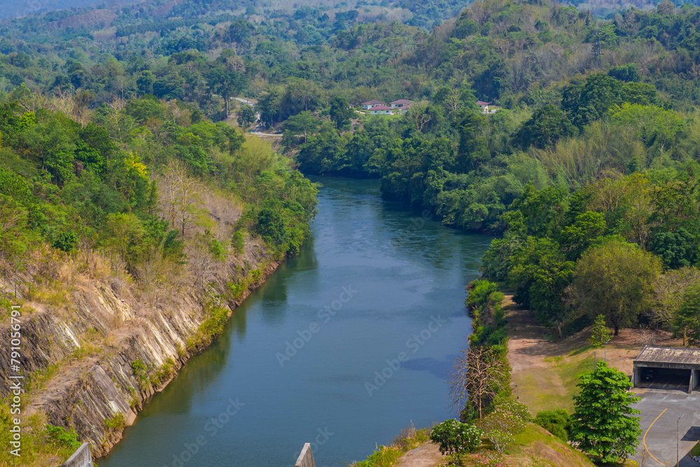 An aerial view of the dam-caused canal in Thailand's national park, with a mountain the background. Bird eye view. An aerial view of the dam-caused canal in Thailand's national park, with a mountain the background. Bird eye view.