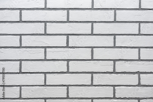 Decorative plaster in the form of white brick on the wall