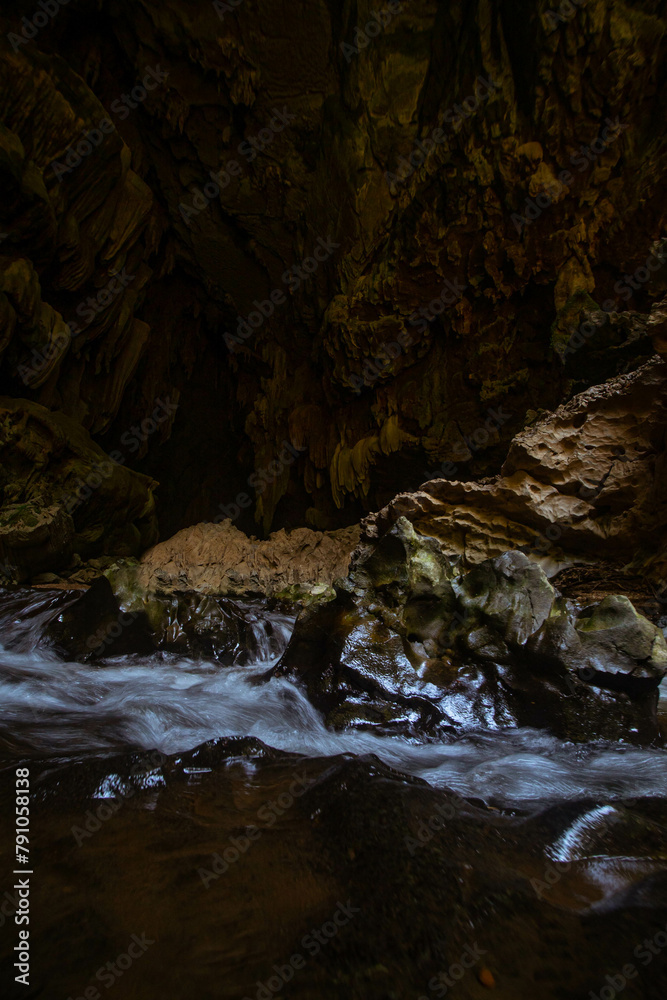 The beautiful views of the stalactite and stalagmite-filled cave in Lam Khlong Ngu National Park, Thailand. At the cave's exit is a small waterfall also. The beautiful views of the stalactite and stalagmite-filled cave in Lam Khlong Ngu National Park, Thailand. At the cave's exit is a small waterfall also.