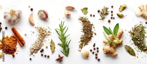 Background of seasoning. Dried spices such as ginger, garlic, rosemary, and bay leaf on a white background, seen from the top with space for text.
