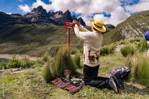 Andean man performing ritual of payment to the land in Peru, payment to the Pachamama