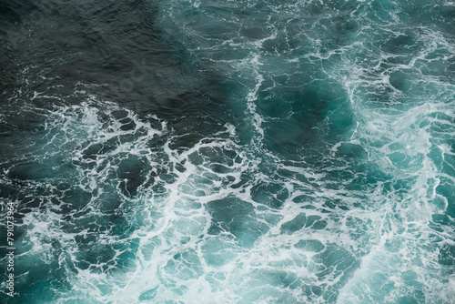 Moody Seascape: Dark Blue Waves Crashing with Dramatic Sky