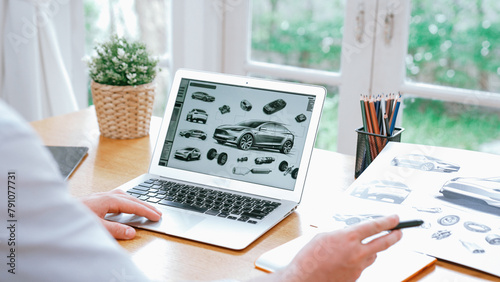 Car design engineer analyze car prototype for automobile business at home office. Automotive engineering designer carefully analyze, finding flaws and improvement for car design with laptop Synchronos