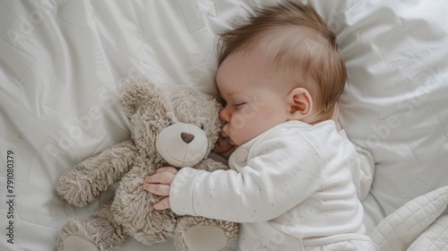 A newborn baby peacefully sleeps on a white bed, cuddled up with a teddy bear