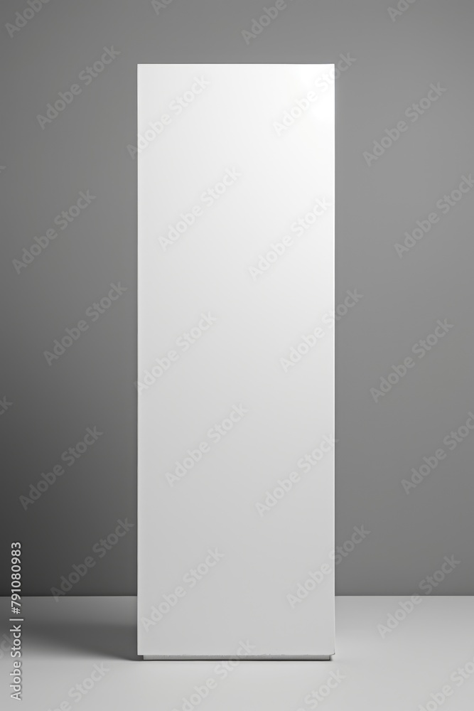A white box is standing on a grey surface A white box is standing on a grey surface