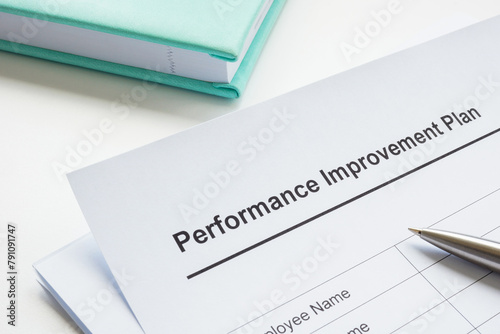 Papers about performance improvement plan and pen.