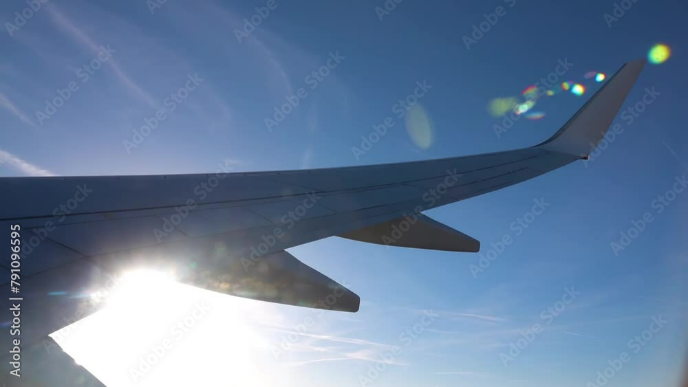 Wing of a flying plane on a background of blue sky and clouds. Wing of a flying plane on a background of blue sky and clouds.