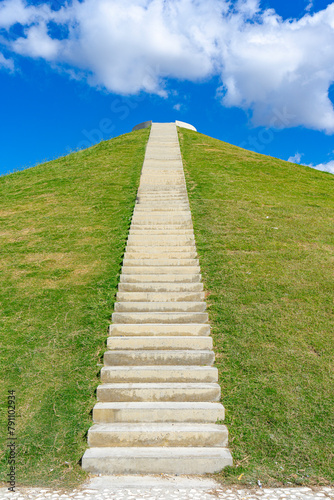 Volcanic cone-shaped grassy hill with grand staircase, city of Vlore, Albania.