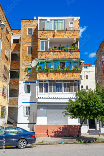 Unplastered housing building with visible bricks in the city of Vlore-Albania.