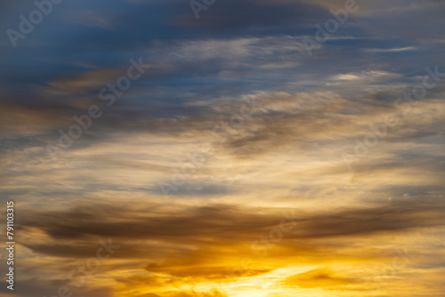 Picturesque view of orange sky with dark clouds in sunset time. Textured background of beautiful sunset. Beautiful background blur.