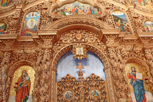 beautiful iconostasis in church. Wooden iconostasis decorated with icons © alexmak