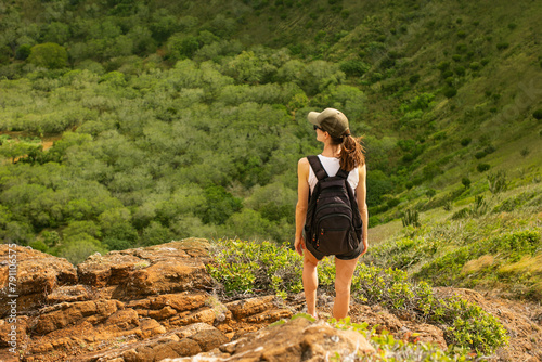 Female hiking through the green mountain countryside 