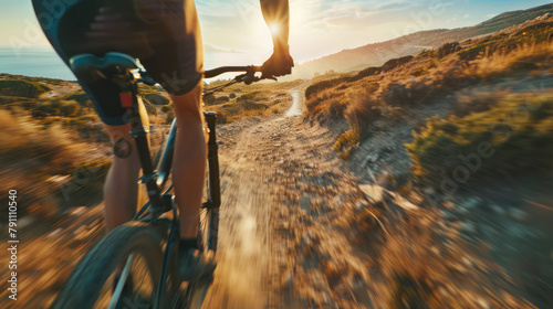 mountain biker riding on a dusty trail at golden hour