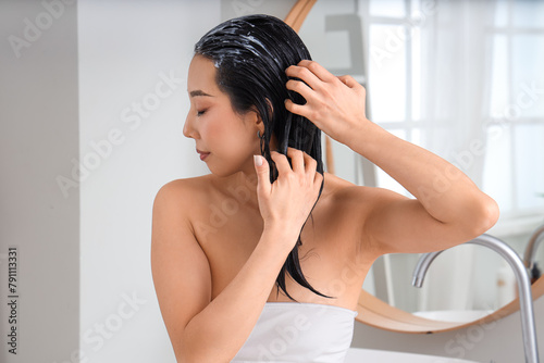 Young Asian woman applying ...
