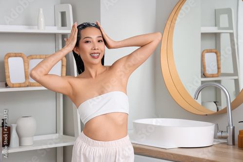 Young Asian woman applying ...