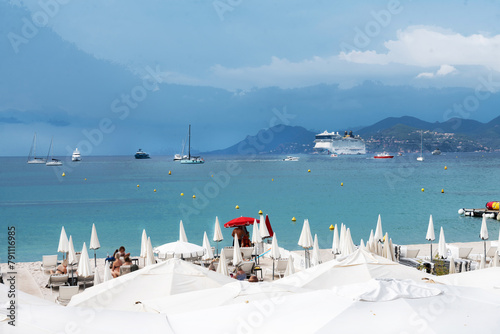 Zen-like paanorama of Cannes bay   from Croisette with anchored boar and cruise ship and distance