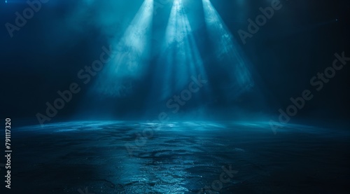 Abstract dark background, blue light rays and mist on asphalt floor. Night scene with spotlight.