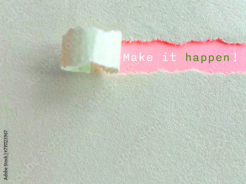 Inspirational Quote - Make it happen text behind torn paper background. Stock photo.