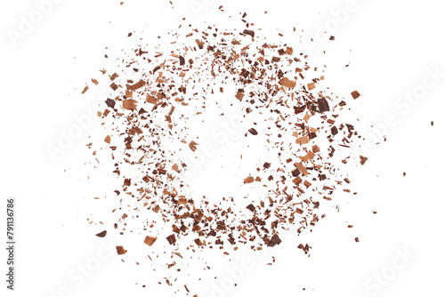 Pile chopped, milled dark chocolate flying isolated on white, top view