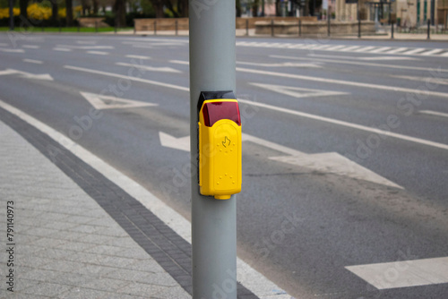 Crosswalk. Yellow button on a traffic light for pedestrians