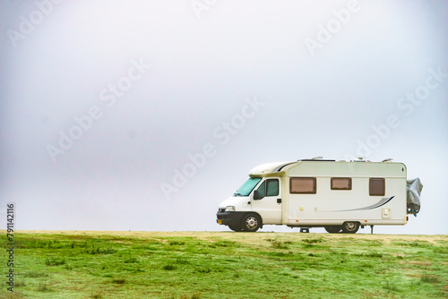 Camper rv camping on nature. Foggy day