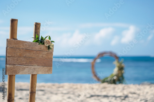 round wedding gate on a beautiful beach with palm trees by the ocean and a wooden sign in boho style for wedding, generative AI