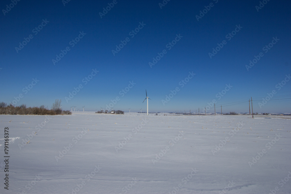 snow covered landscape with wind turbines