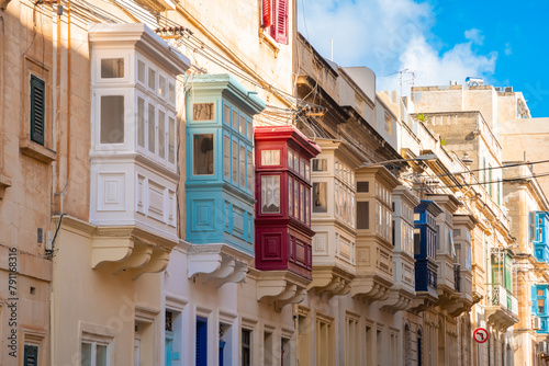 Cozy street and traditional colorful wooden balconies in Sliema, Malta