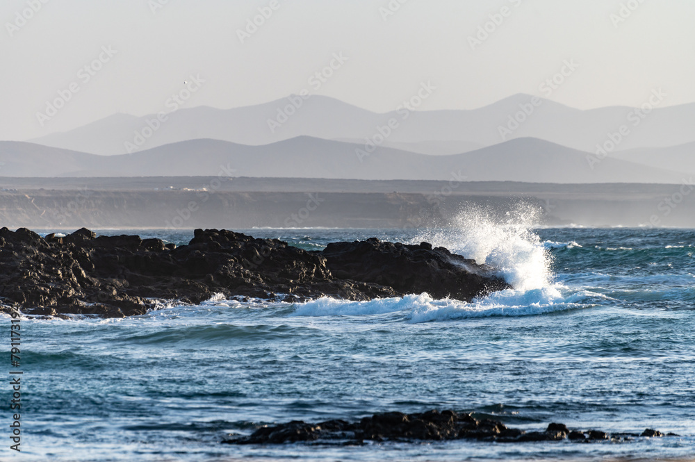 Fototapeta premium West coast of Fuerteventura island. Winter sea and sun vacation in El Cotillo touristic village, Canary islands, Spain. White sandy beach La Concha..