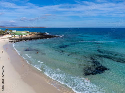 Caleta del bajo, corralejo grandes playas white sandy beach with blue water near Corralejo touristic town on north of Fuerteventura, Canary islands, Spain