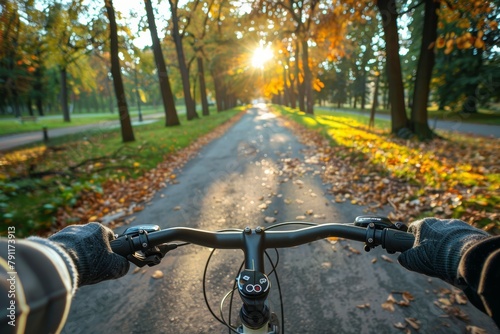 Biking on an asphalt road through scenic woods with grass, trees, and plants