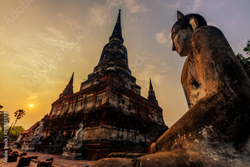 The background of important religious attractions, Wat Yai Chai Mongkhon, has an old Buddha statue and a large pagoda for tourists to study the history of Ayutthaya in Thailand. © bangprik