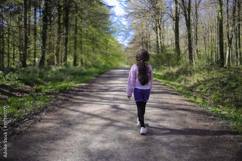 girl walking on the forest path