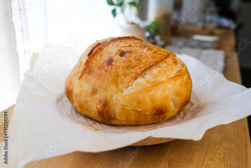 Homemade artisan or sourdough bread. on the kitchen counter top.