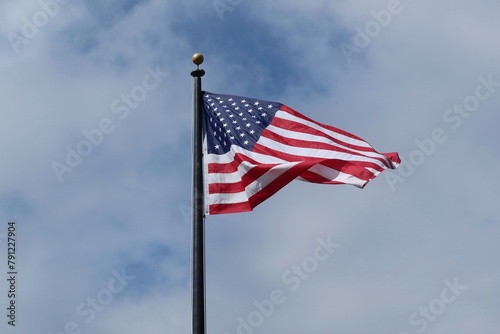 American flag on blue sky background
