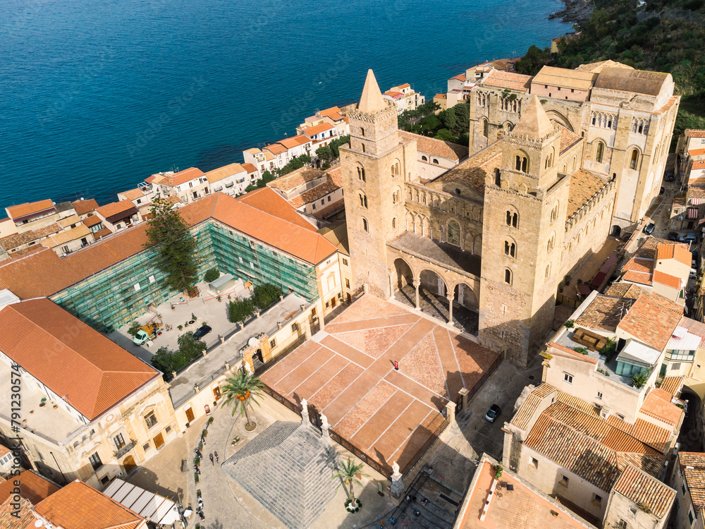 Cefalu, Italy: Aerial view of the Norman mediveval cathedral, also called the Duomo di Cefalu in Italian, in the famous Cefalu old town in Sicily, Italy.