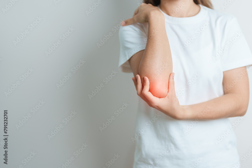 Woman having elbow ache at home, muscle pain due to lateral epicondylitis or tennis elbow. injury, Health and medical concept