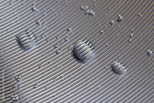 Abstract background of water drops on an aluminum surface with radial paths, thin parallel lines on metal and water drops