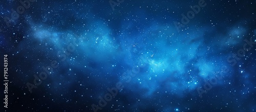 An up-close view of a clear blue sky with twinkling stars and a scattering of fluffy clouds