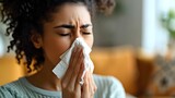 Woman blowing her nose with a tissue to manage cold symptoms during allergy season. Concept Allergy season, Cold symptoms, Tissue use, Stuffy nose, Woman's health