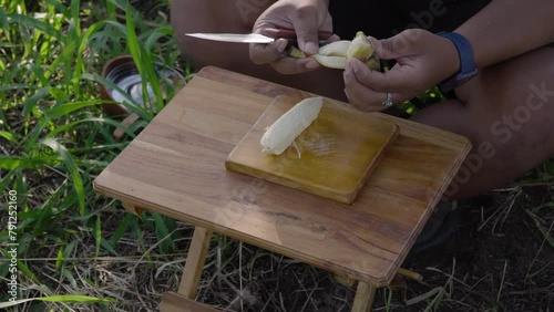 Bushcraft concept of cooking banana compote to break the fast in the forest with ASMR sounds. Close up of cooking activities in nature with minimal equipment in a calm and comfortable atmosphere photo