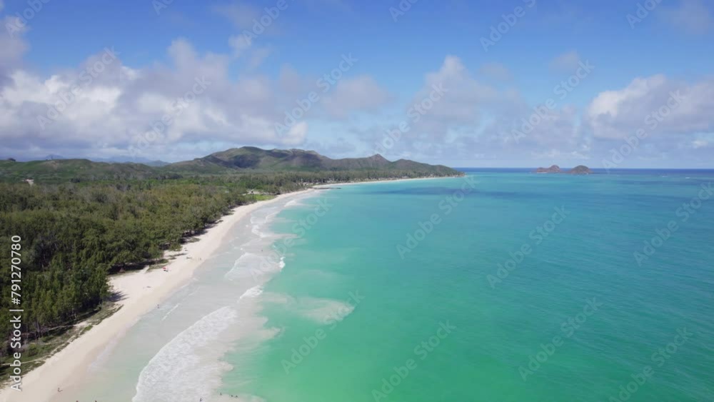 turquoise water meets white sand and lush green mountains in this drone footage of paradise with blue sky and puffy white clouds on the island of Oahu Hawaii turquoise water meets white sand and lush green mountains in this drone footage of paradise with blue sky and puffy white clouds on the island of Oahu Hawaii