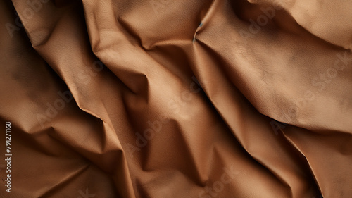Rich brown fabric with deep folds creating a dynamic textured look.