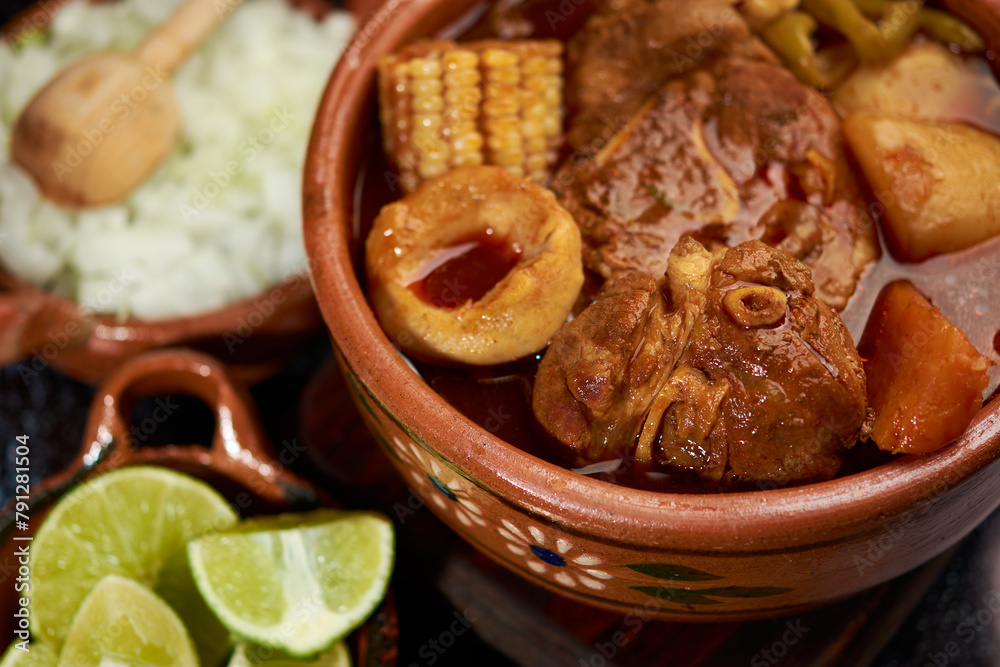 Chilatole with pork, vegetables, carrots, green beans, potatoes, corn and dough ears, served on a clay plate, along with some lemons and onions, Veracruz food from the region. Chilatole with pork, vegetables, carrots, green beans, potatoes, corn and dough ears, served on a clay plate, along with some lemons and onions, Veracruz food from the region.