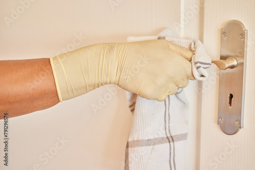 Φωτογραφία Cleaning, door handle and cloth in a home with a cleaner, maid and gloves with disinfection