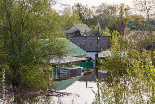 Flood in Kazakhstan. A flooded car and houses in a dacha area. The river overflowed its banks. Cataclysms in Kazakhstan.