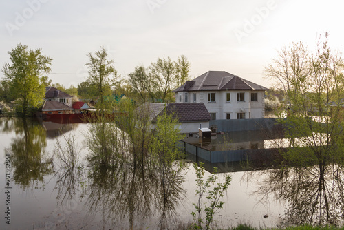 Flood in Kazakhstan. Flooded yard and two-story house in a dacha area. The river overflowed its banks. Cataclysms in Kazakhstan.