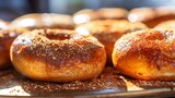 Close-up of cinnamon sugar bagels, showcasing the sugary crust and warm, spicy aroma, in a sunlit bakery window. 