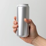 A hand holding a can of soda